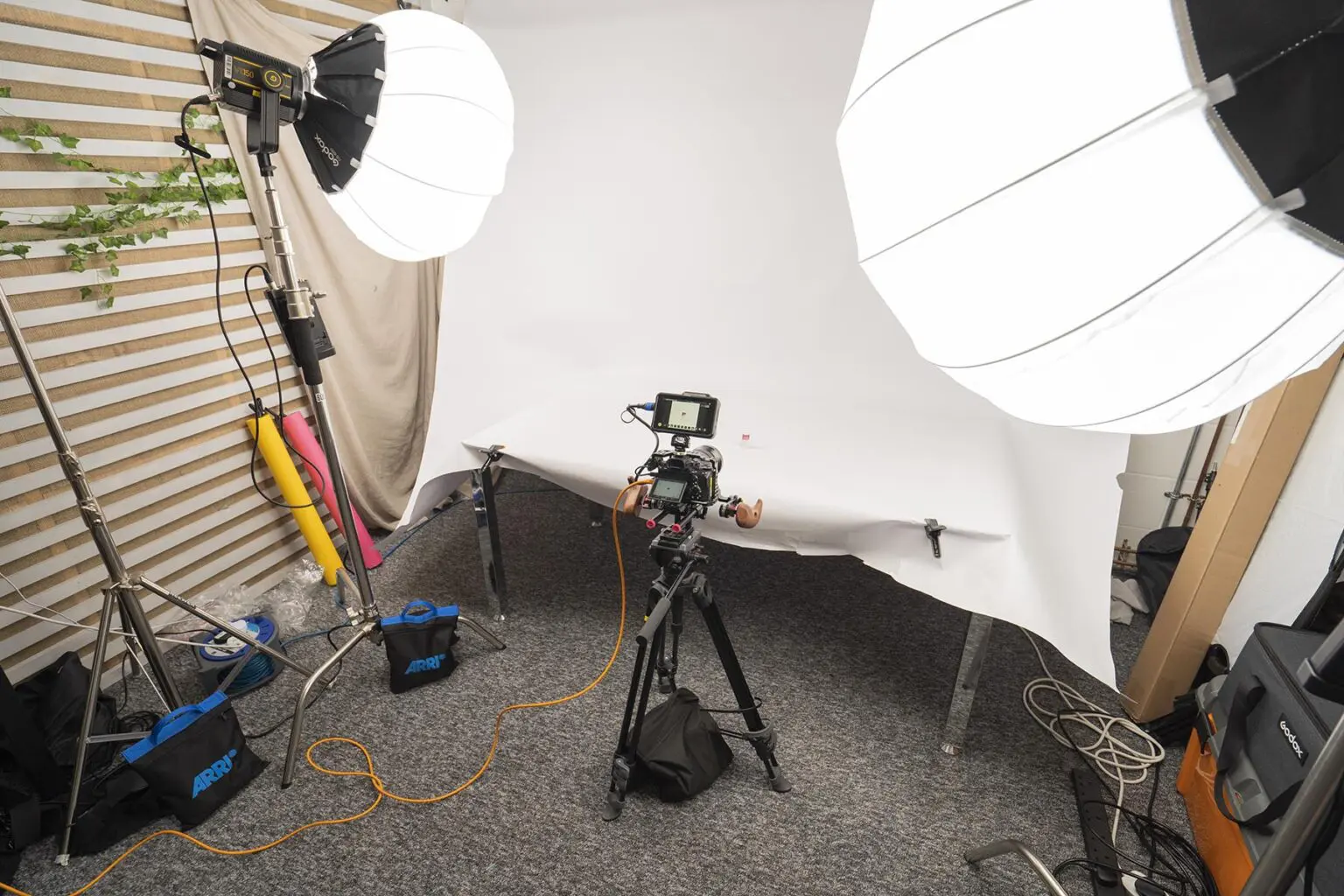 Product filming set up, white background, lights and camera