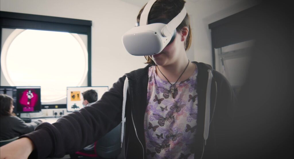 Girl in butterfly top wearing a VR headset