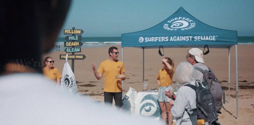 Surfers against Sewage team on the beach for beach clean with gazebo