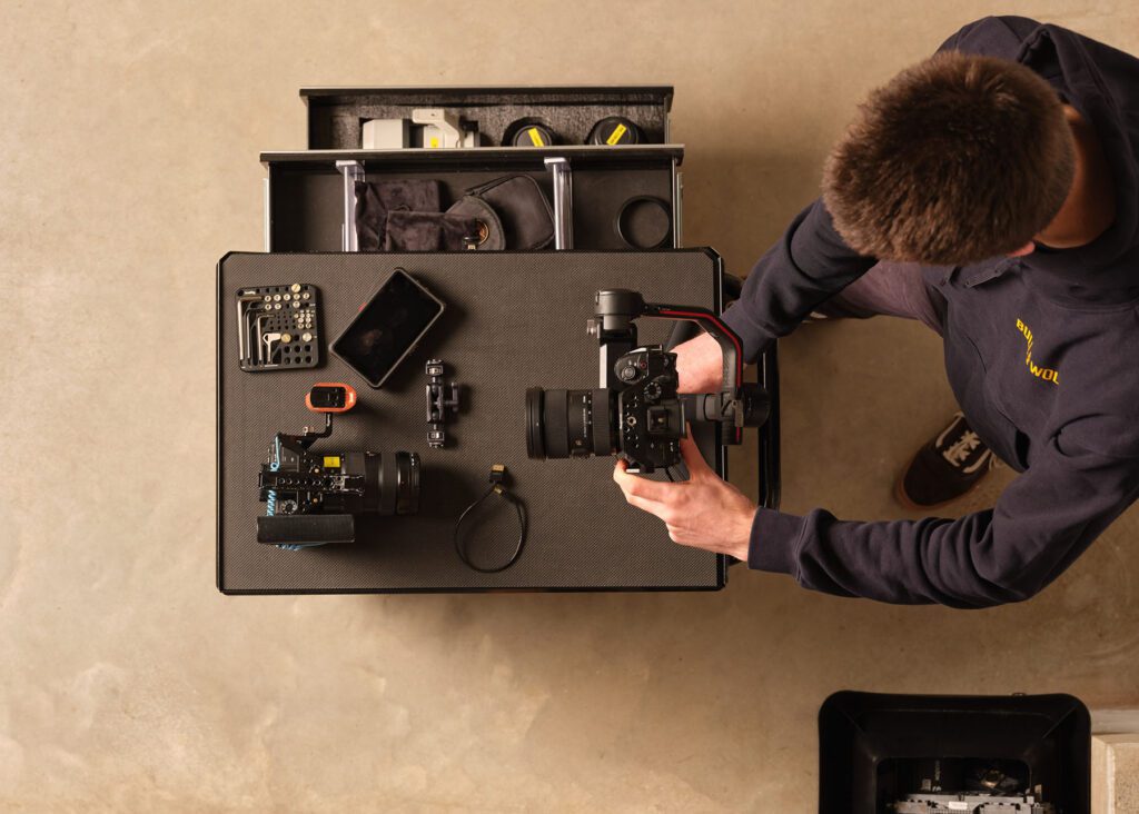 Shot from above of team member sorting out camera equipment